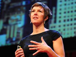 Jessica Green speaking about over-disinfecting on stage during a TED talk