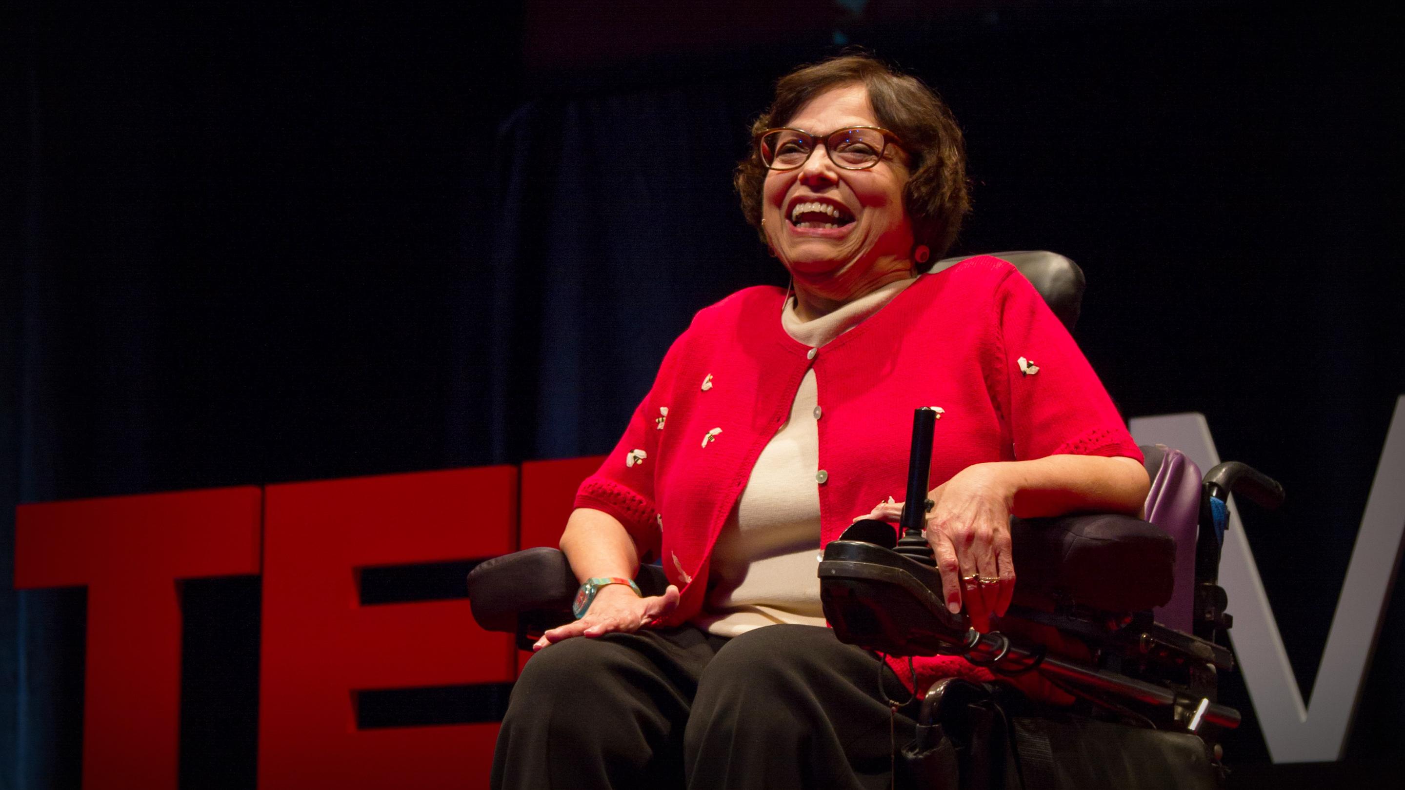Video still of Judith Heumann on the TEDx stage smiling